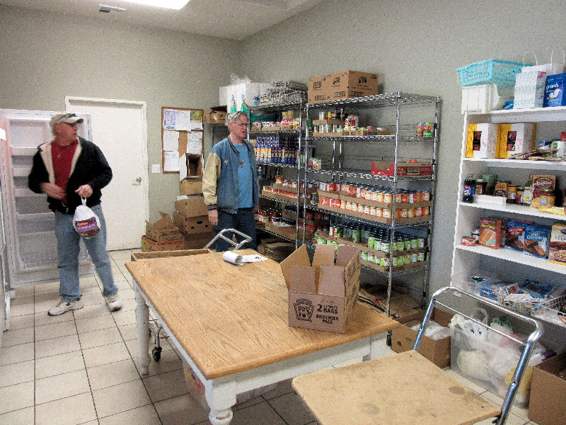 Volunteers stocking the shelves of the Manna House food pantry